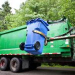 Sanitation truck lifting recycling bin