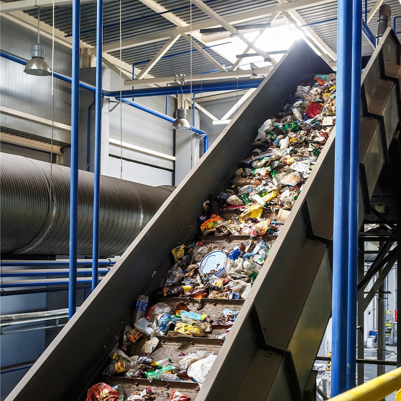 Materials on a conveyor belt in a recycling facility