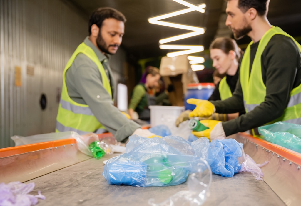 Workers in recycling processing facility