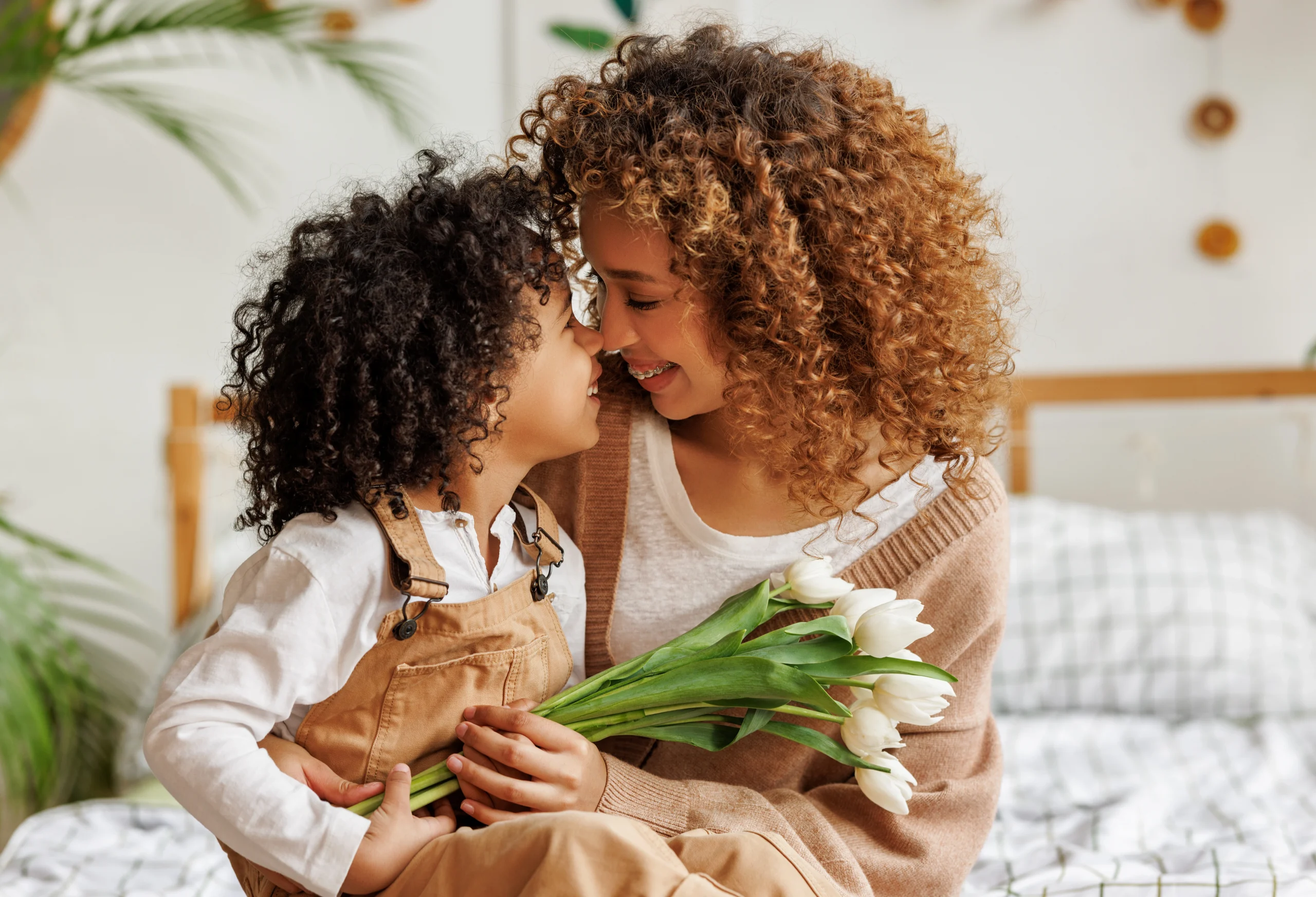 mom and son. mom holding flowers